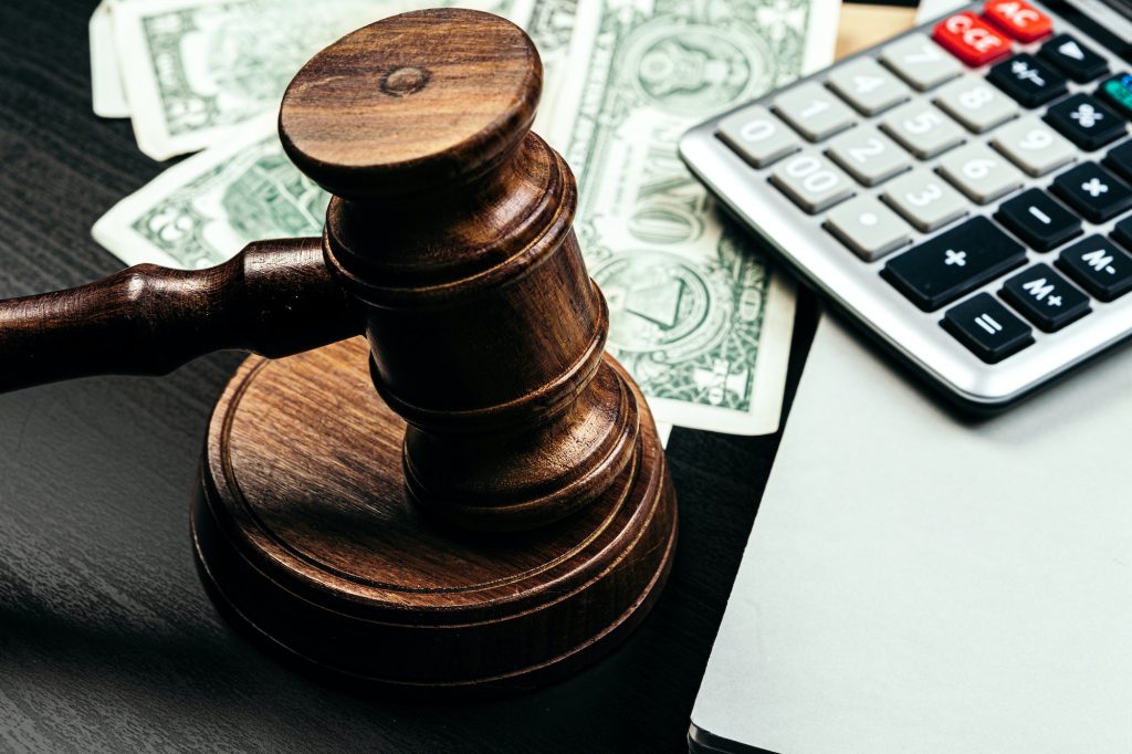 Business finance, corruption concept. Wooden gavel with american dollars